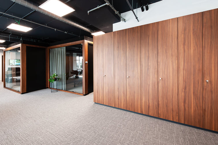 Long wall of cabinets made of Lorenzo medium brown HPL panels.